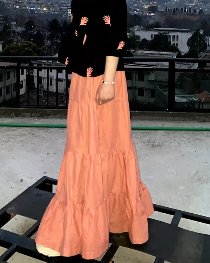 Peach cotton tiered long skirt styled with fusion shirts for women
